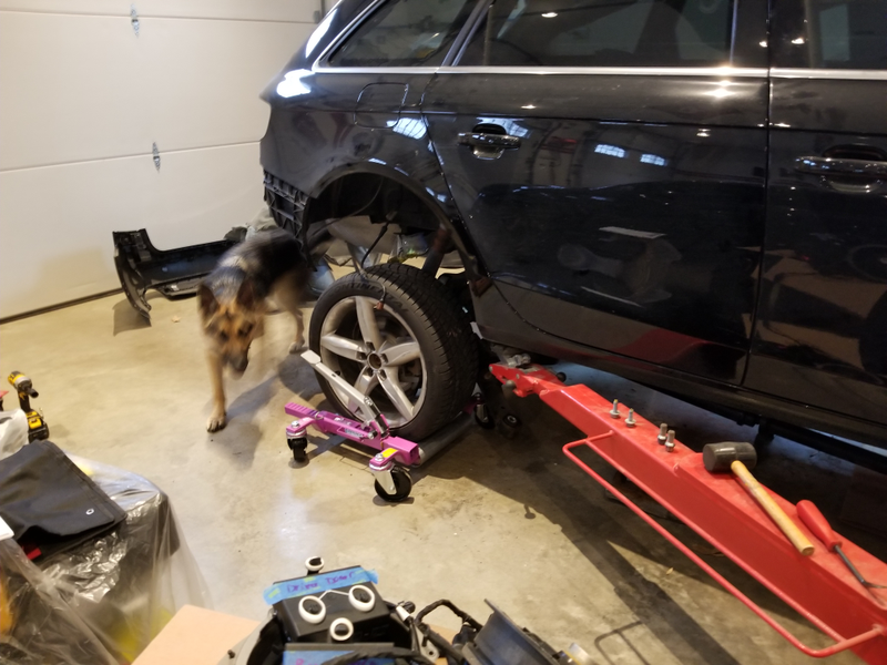 One of Chuck’s helpers on this build helps remove the A4's rear axle assembly.